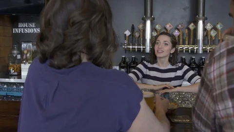 Waitress talking with guests in a bar 動画素材 77079317