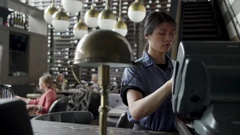 Waitress using touch screen cash register in wine bar Stock Footage 220358028