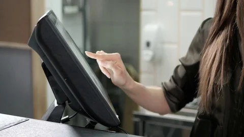 Waitress using a touchscreen in a restaurant near cashbox, close up of woman 動画素材 75460643