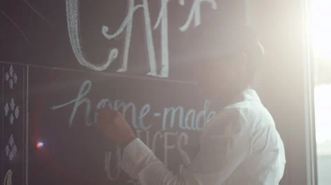 Waitress writing on blackboard menu in cafe. Stock Footage 64099636