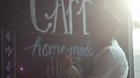 Waitress writing on blackboard menu in cafe. Stock Footage 64099744