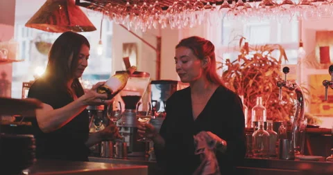 Waitresses having afterhours drink Stock Footage 203583800