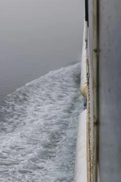 The wake along the side of a vessel. Stock Photos
