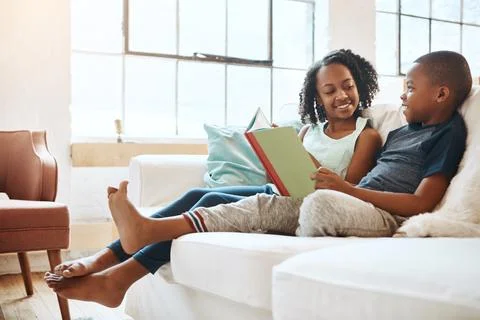 Wake up and read to keep your mind active. a little brother and sister reading a Foto stock