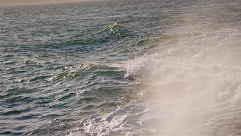 Wake and surf behind moving boat, with smoke from engine in foreground Video stock 242861363