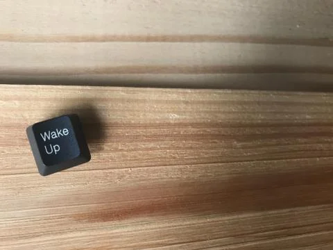 The wake up black button on rubberwood table in studio Stock Photos