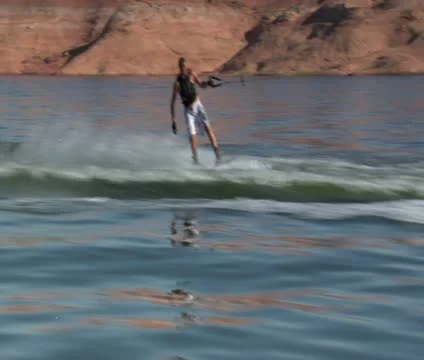 Wake boarder uses one hand on tow rope Stock Footage 21660512