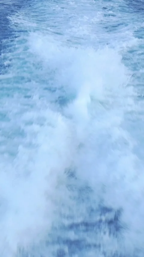 Wake of boat cutting through expansive ocean, symbolizing adventure and Stock Footage 281341937