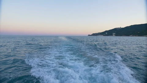 The wake of a boat as seen from the side of a ship. Stock Footage 89833576