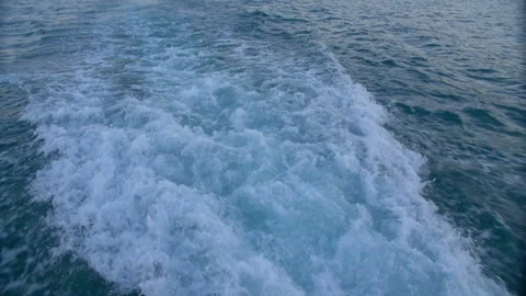 The wake of a boat as seen from the side of a ship. Stock Footage 89833713