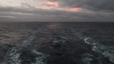 Wake of the cargo ship under cloudy sky in open sea. Stock Footage 138749164
