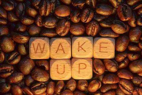 Wake up message with coffee beans surrounding wooden blocks letters Stock Photos