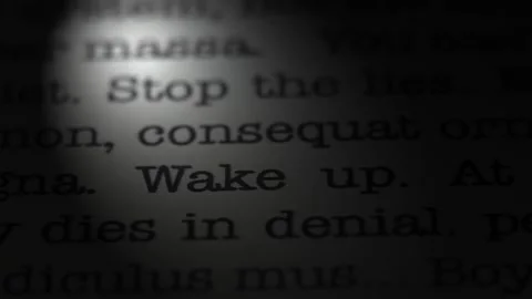 Wake up. Moving text printed on a page. Slow motion. Stock Footage 307286205