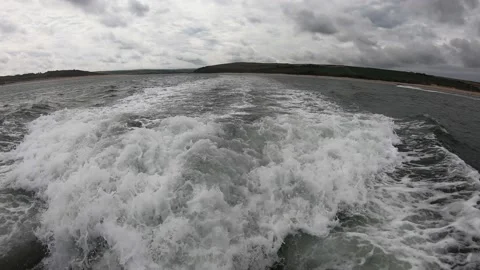 Wake or back wash being created by a fast moving fishing boat Stock Footage 146082371