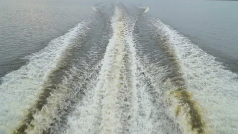 The wake from a power boat going at full speed through the water in slow motion Stock Footage 98258643