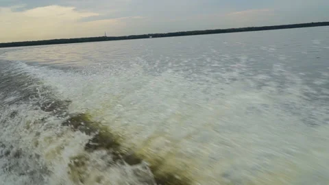 The wake from a power boat going at full speed through the water in slow motion Video stock 98264622
