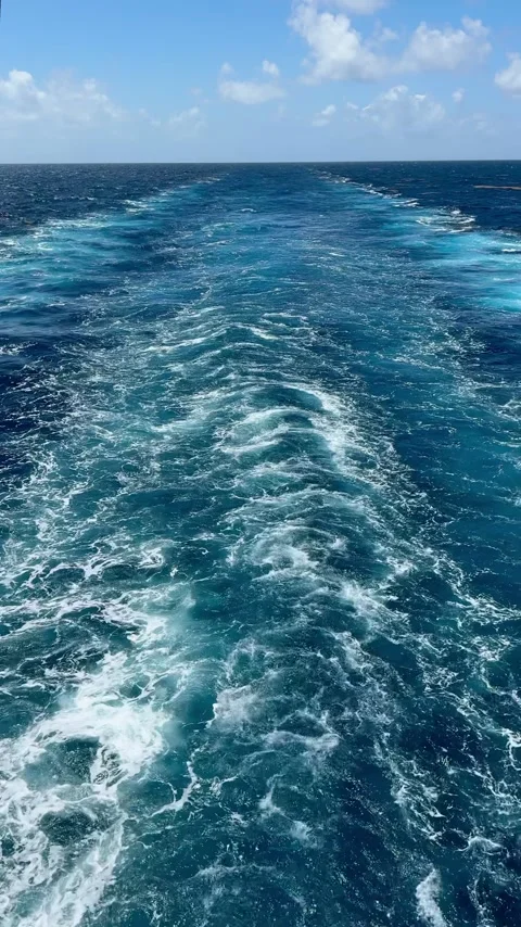 Wake trailing behind a moving cargo ship Stock Footage 335669031