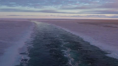 Wake of vessel in ice. Wide wake trail from boat. Back view. Ocean water. Trace Stock Footage 229892803