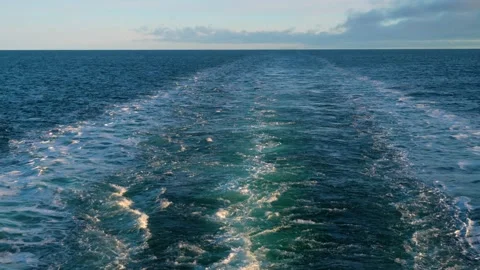 Wake of vessel. Wide wake trail from boat. Back view. Ocean water. Deep green Stock Footage 221572136