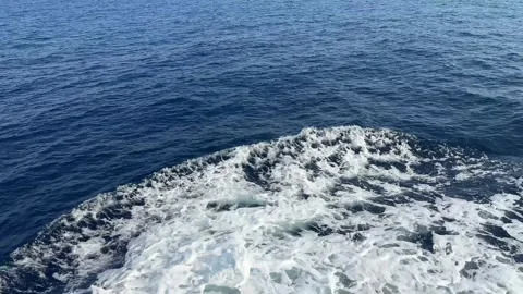 Wake of vessel. Wide wake trail from boat. Back view. Ocean water. Deep blue. Vídeo Stock 282431606