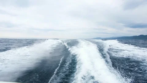 Wake wave of a small boat, proceeding from Rausu through the Nemuro Straits. Video stock 328485236