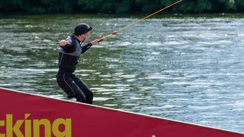 Wakeboarder balancing on kicker during cable wakeboarding Photos