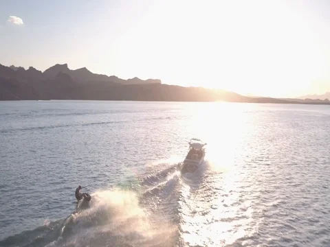 Wakeboarder behind Boat Heading into the Sunset Stock Footage 84043564