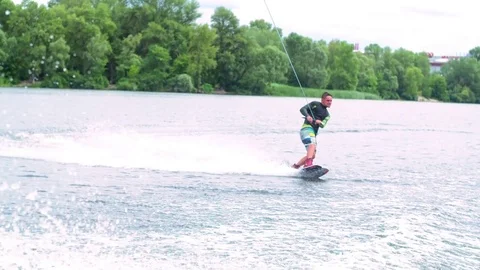 Wakeboarder doing tricks HD wakeboarding slow-motion pov video. Man jumps flip Stock Footage 79240062