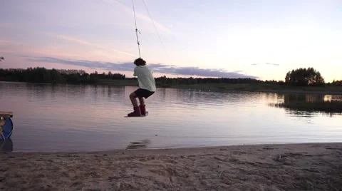 Wakeboarder droping off from sand coast Stock Footage 67354933