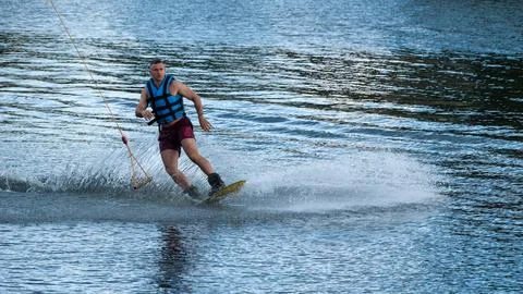 Wakeboarder gliding after release of cable tow handle Photos
