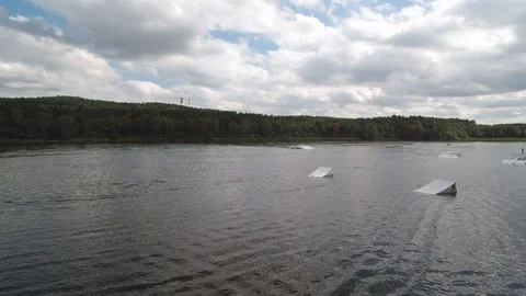 Wakeboarder on Lake doing tricks Stock Footage 107614309