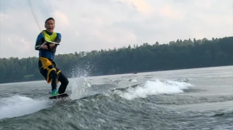 Wakeboarder man in diving suit riding the wave and crush in water Stock-Footage 66975482