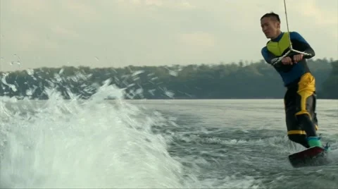 Wakeboarder man riding the wave, making tricks and jump the water Video stock 66974921