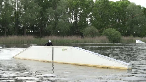 Wakeboarder performing 360 over a slider [Slomo] Stock Footage 70133227