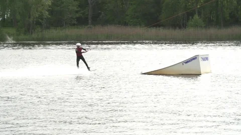 Wakeboarder performing a 720 over a kicker [Slomo] Stock Footage 70132963