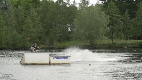 Wakeboarder performing a raley on a kicker at local cable park [Slomo] Stock Footage 70157917
