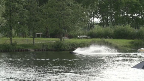 Wakeboarder performing a S-bend at a local cable park [Slomo] Stock Footage 70132918