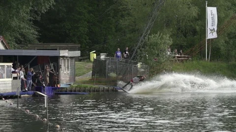 Wakeboarder performs a back-roll close to the start [Slomo] Stock Footage 70133118