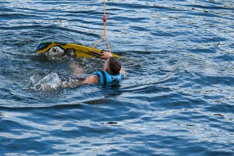 Wakeboarder repositioning after fall during cable wakeboarding session Photos