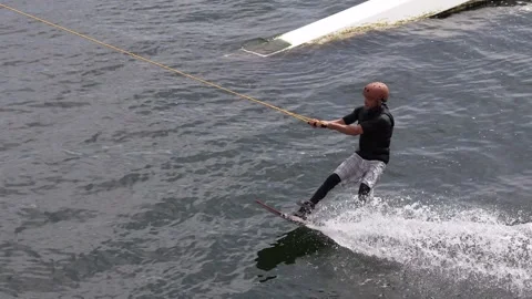 Wakeboarder ride on cable wakeboard in park, outdoor extreme on water Stock Footage 249196808