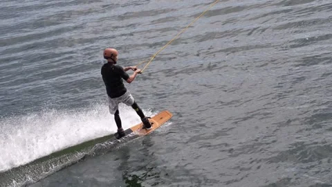 Wakeboarder ride on cable wakeboard in park, outdoor extreme on water Stock Footage 249272187