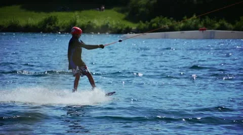 Wakeboarder riding a cable skiing system Stock Footage 22241785