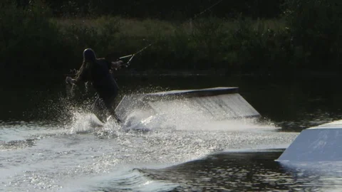Wakeboarder slow motion rail slide Stock Footage 80165040