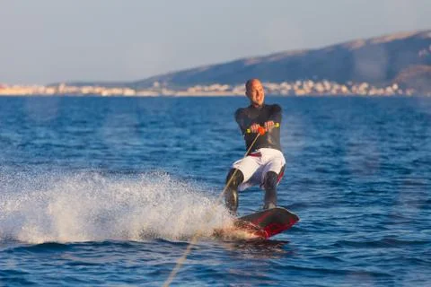 Wakeboarder in sunset. Stock Photos