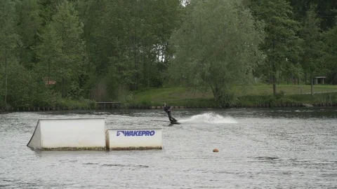 Wakeboarder tries to do 720 over kicker [Slomo] Video stock 70133740