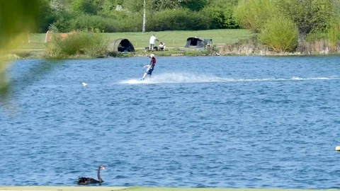 Wakeboarding over a jump in slow motion Stock Footage 106990337