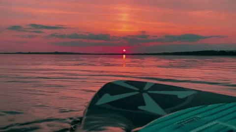 Wakesurf board in water on the setting red sunlight Stock-Footage 212005802