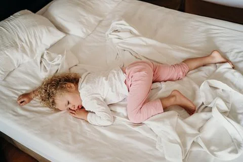 Waking up a child in bed Stock Photos
