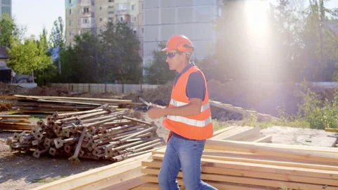 Waking up Forman at construction site he take the ration and start talking with Stock Footage 148225948