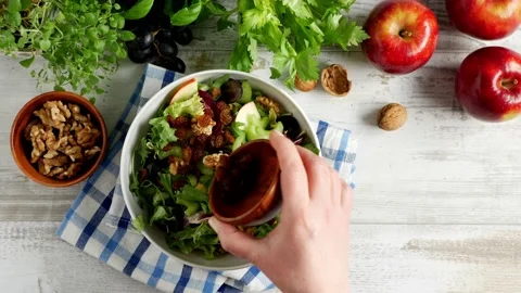 Waldorf salad. Adding raisins to a dish. Stock Footage 139740116